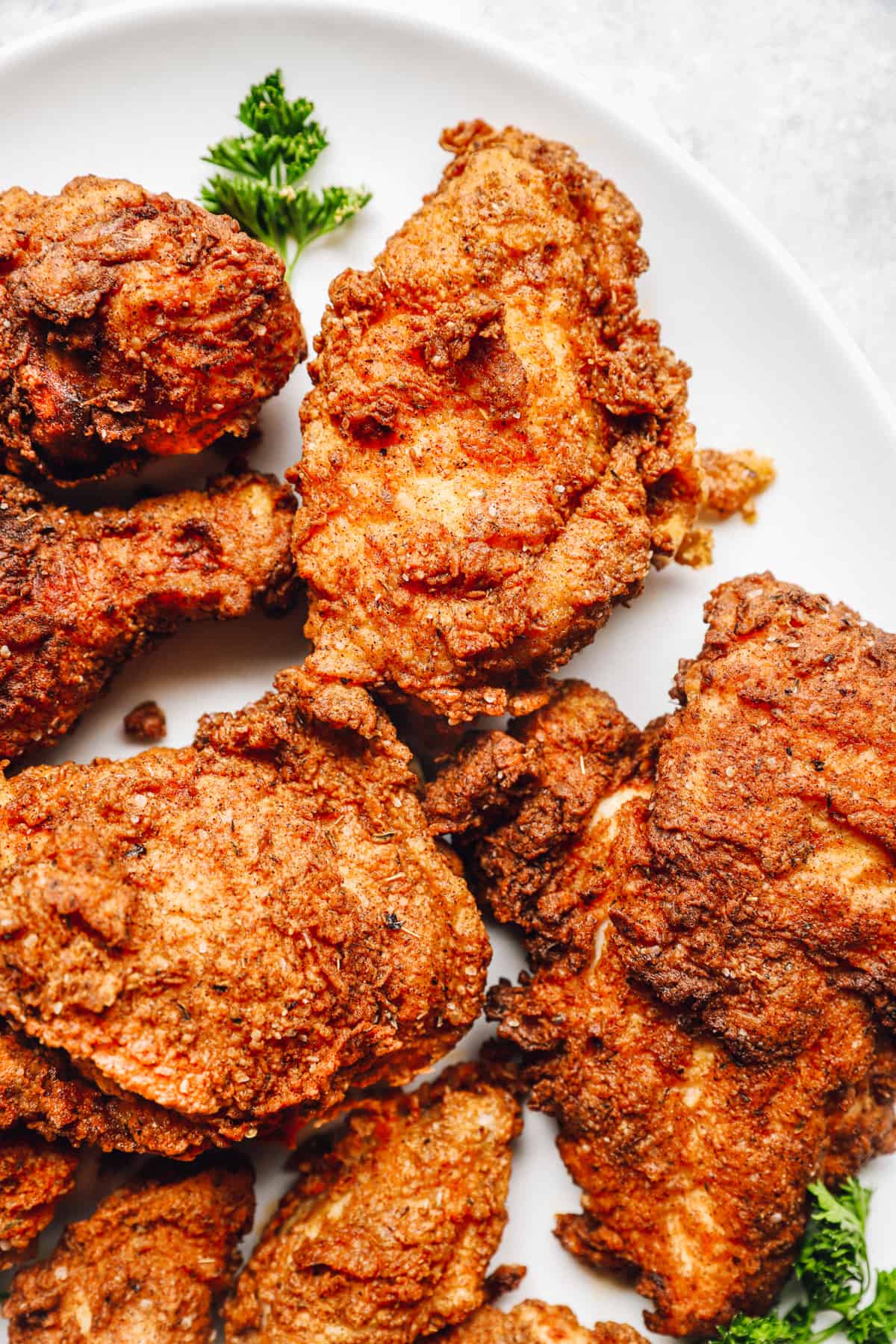 homemade kentucky fried chicken on a white plate.