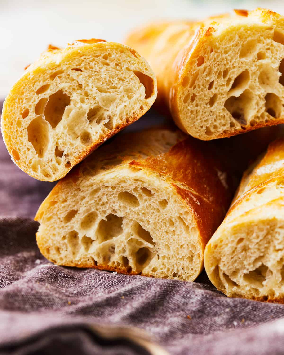 Four slices of French baguette on a cloth.