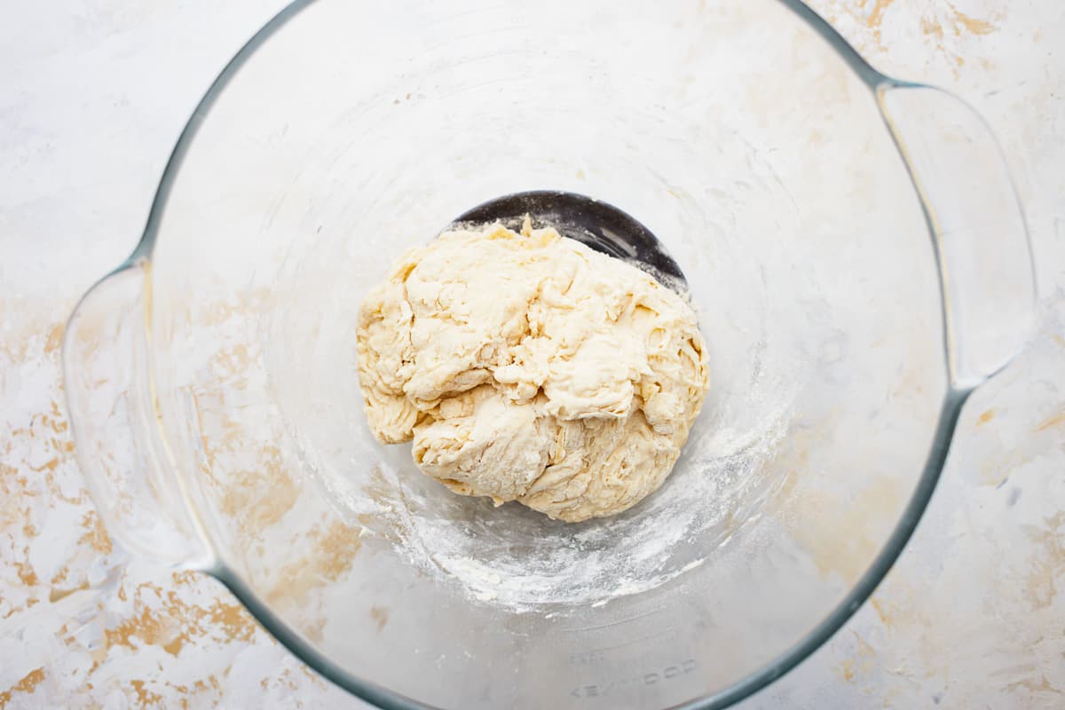 Bread dough in a glass bowl.