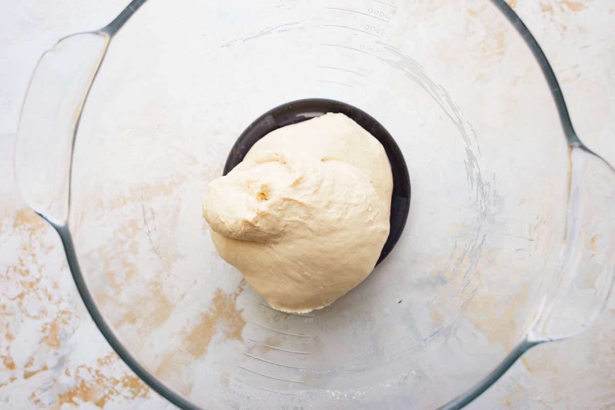 A dough ball in a glass bowl.