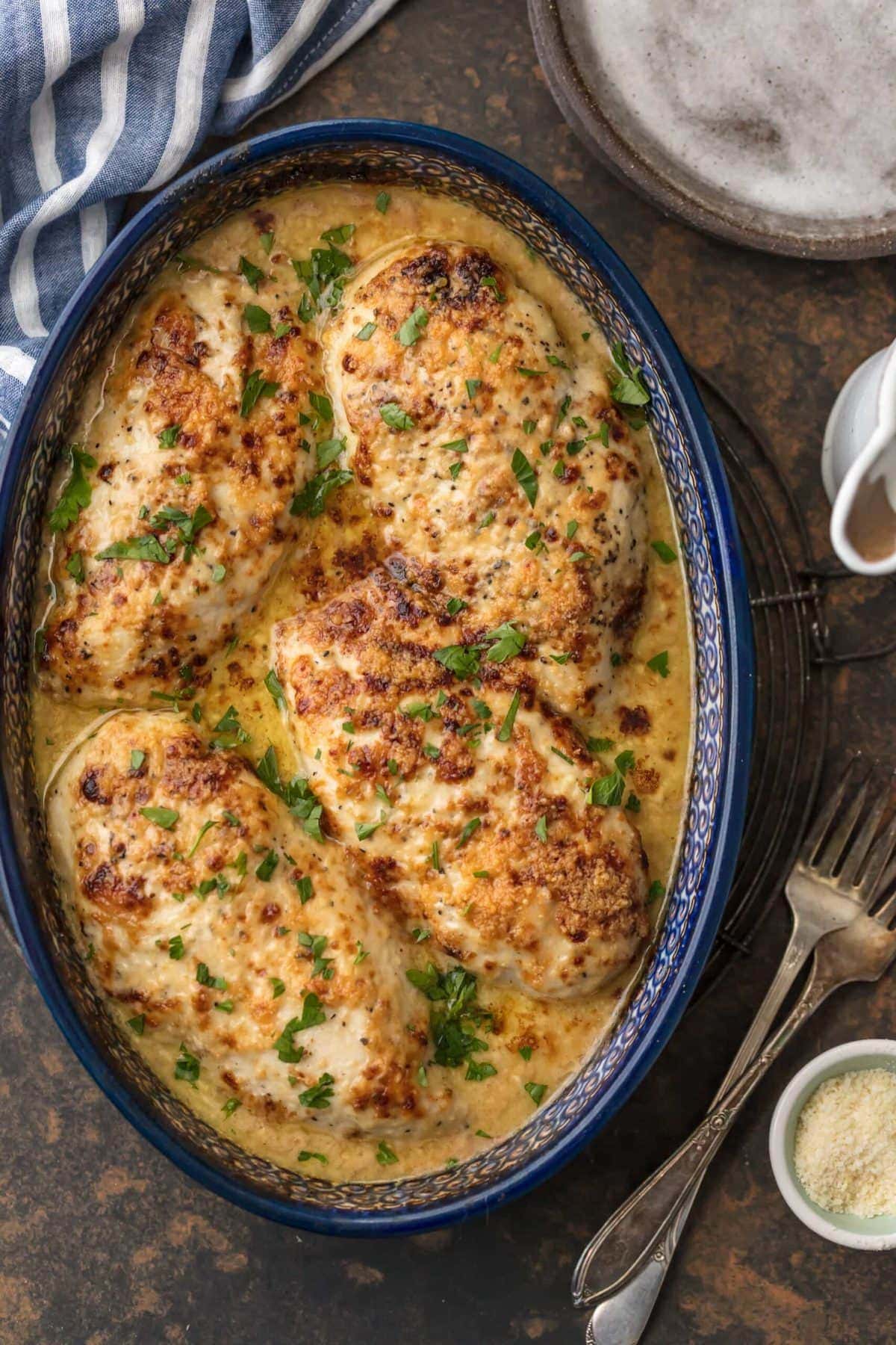 melt in your mouth caesar chicken in a blue casserole dish