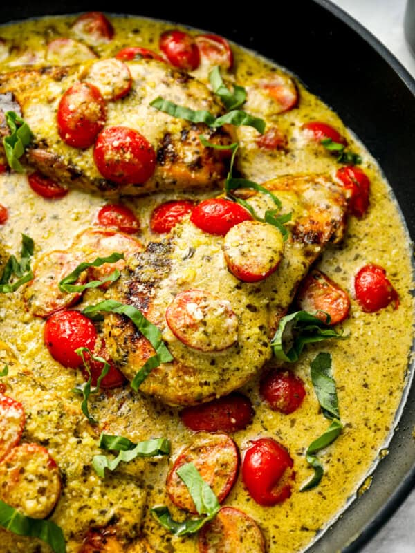 pesto chicken in a skillet.