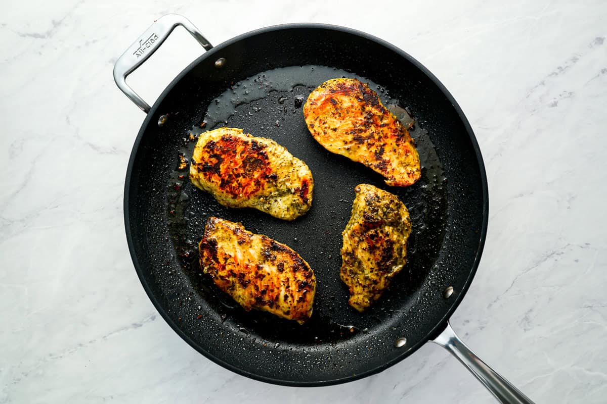 cooked chicken breasts in a skillet.