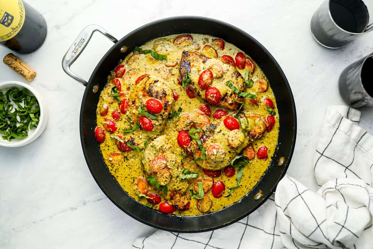 pesto chicken in a skillet.
